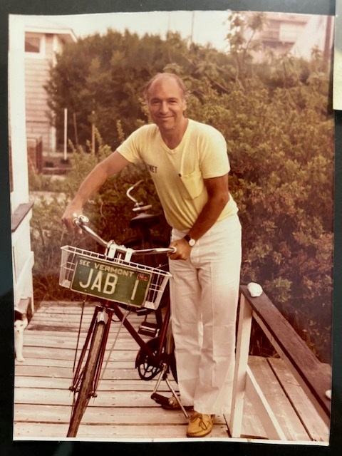 A person standing on a wooden deck with a bicycle

Description automatically generated